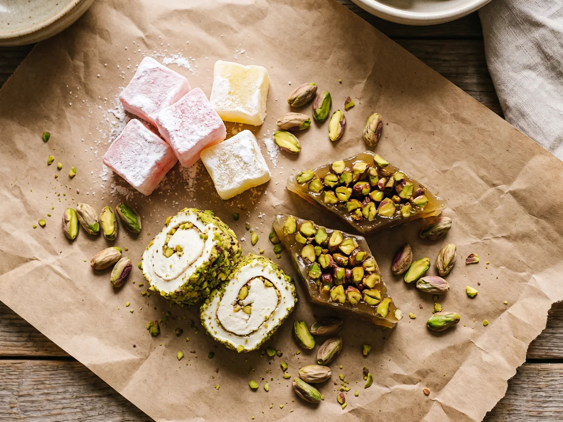 Classic cubes, pistachio-coated roll and baklava-style Turkish delight on kraft paper