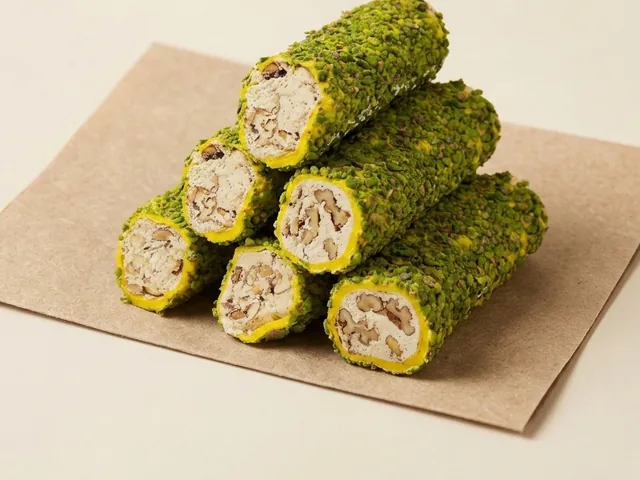 Pistachio-grain coated banana and almond cream roll