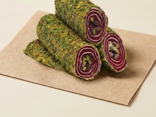 Slivered-pistachio coated pomegranate and pistachio roulade